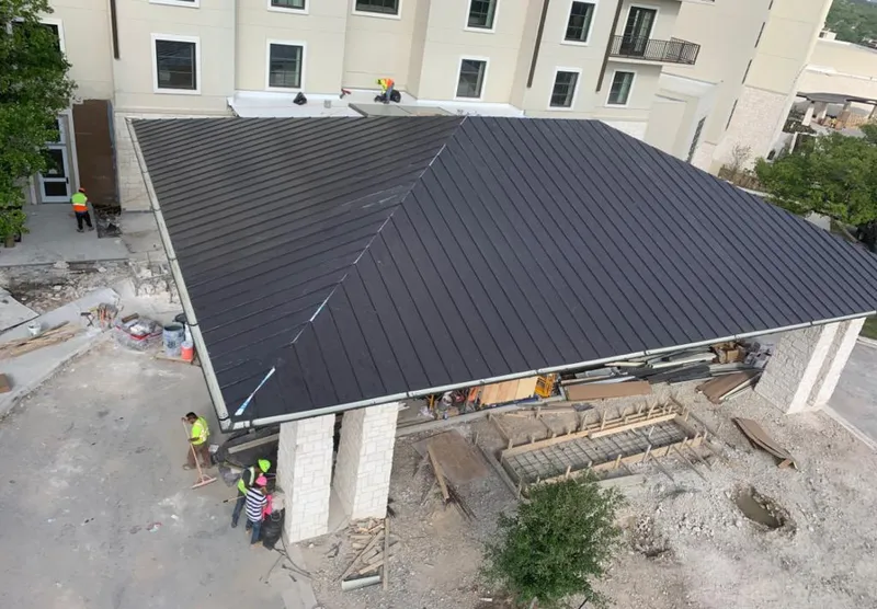Metal roofing installation team working on a commercial building in Douglas